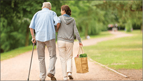 Caregiver – woman helping senior man with shopping